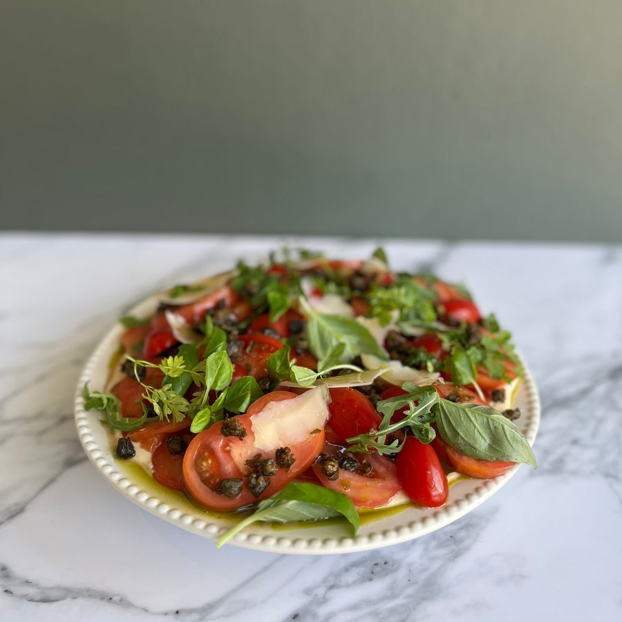 Market fresh heirlooms, nectarines, fior di late, basil on a marbled surface