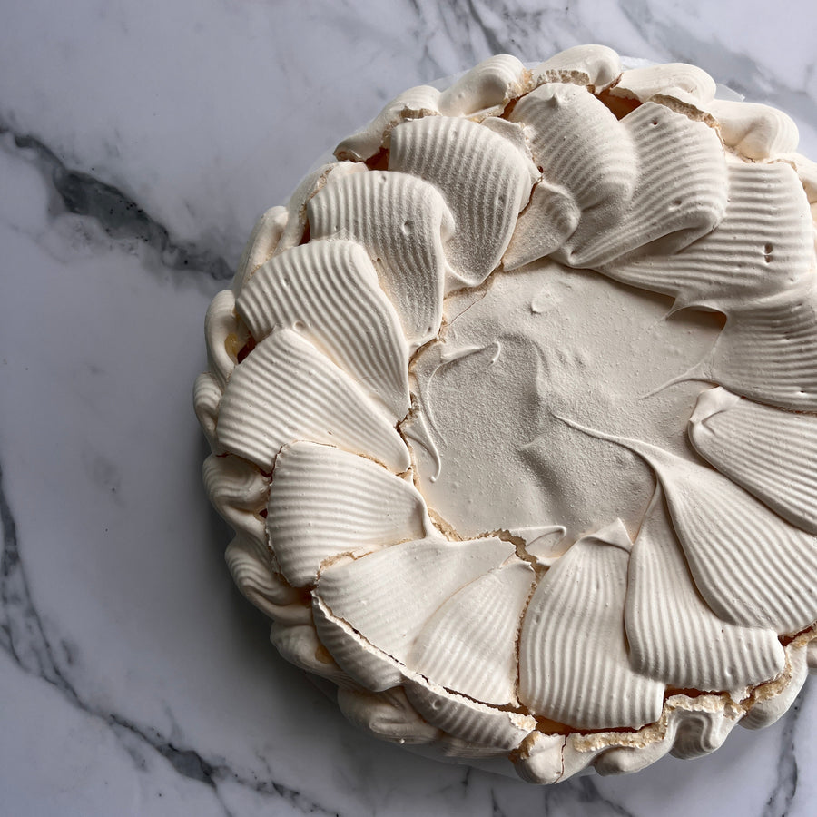 Round pavlova base on a marble top