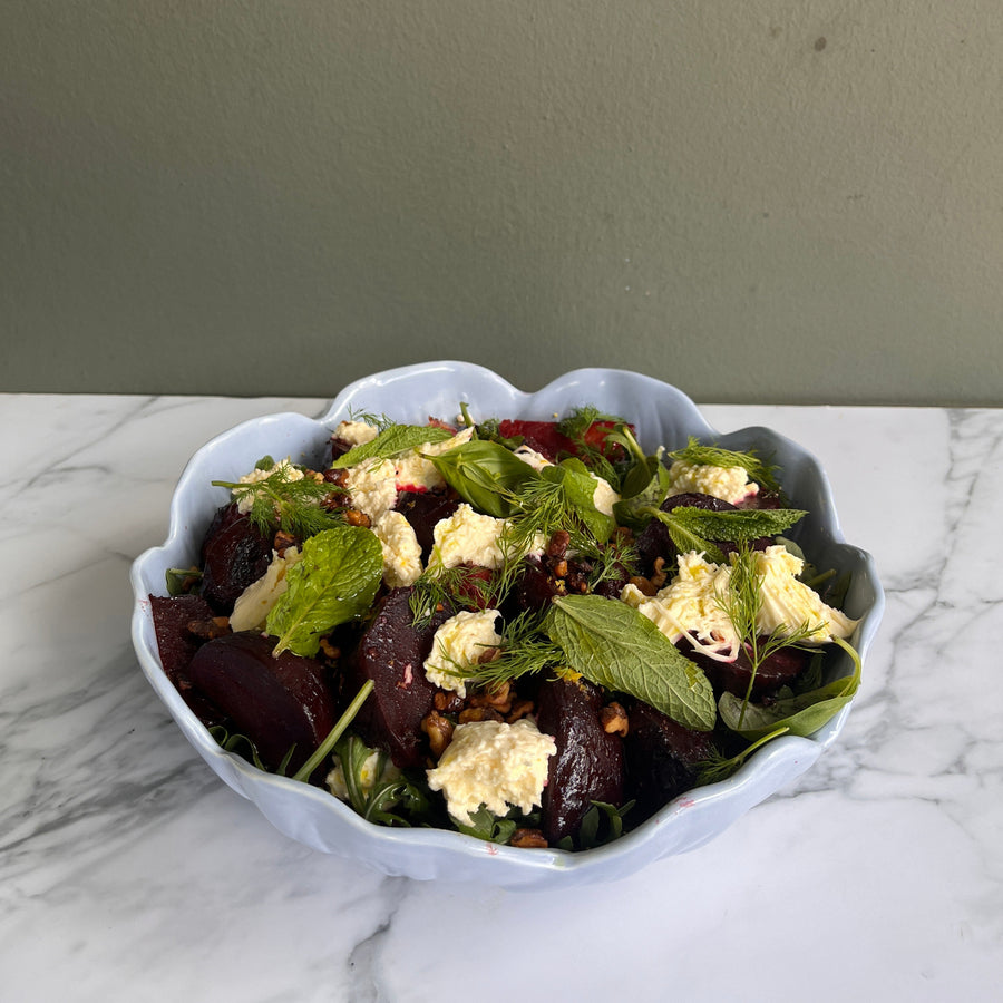 Beetroot salad in a decorative bowl on a marble surface