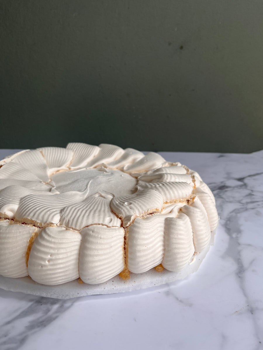 Close-up of a textured pavlova base on a marble surface